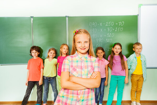 Girl stands with crossed arms