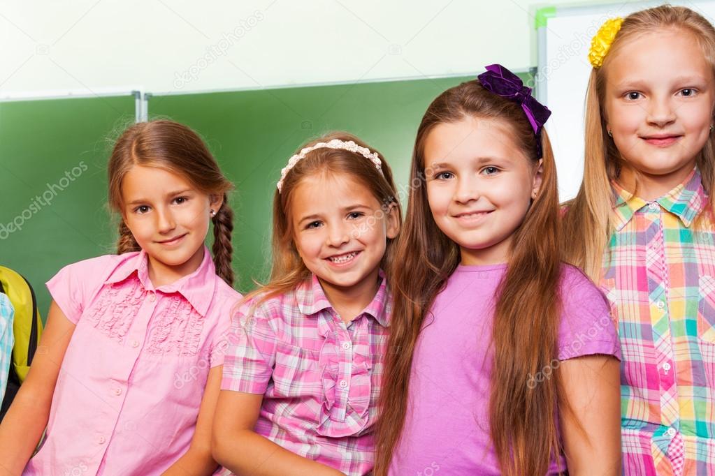 Beautiful girls stand in classroom