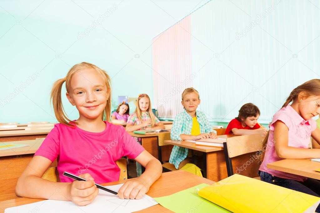 Children writing in exercise books