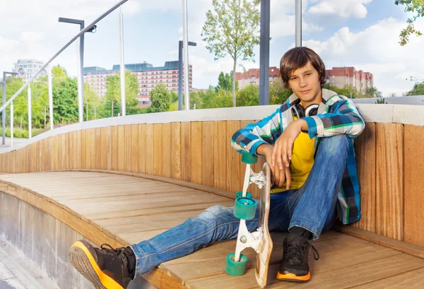 Positive boy holds skateboard — Stock Photo, Image