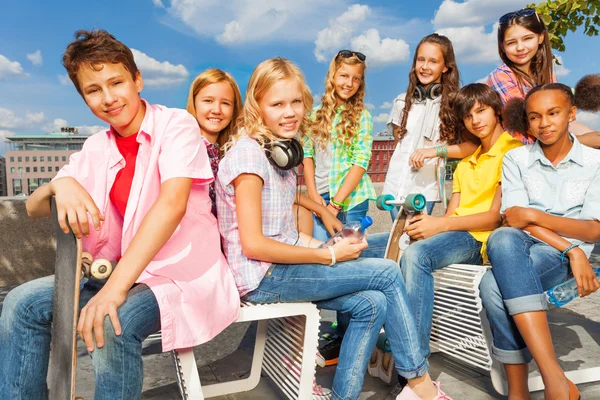 Friends sitting with skateboards — Stock Photo, Image