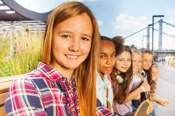 Nice girls sitting on wooden bench — Stock Photo, Image