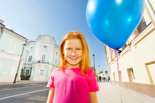 Girl with blue flying balloon — Stock Photo, Image