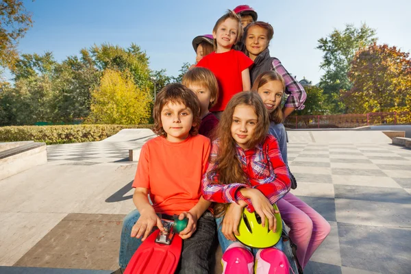 Friends sitting with skateboards — Stock Photo, Image