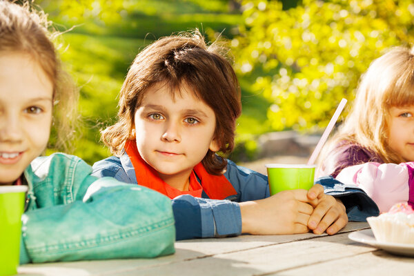 Looking boy and girls with cups