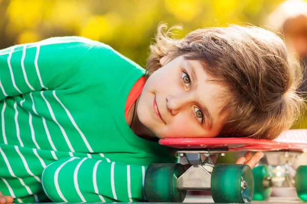 Kleiner Junge liegt auf Skateboard — Stockfoto