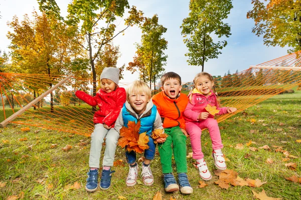 Happy children sitting on hammock — Stock Photo, Image