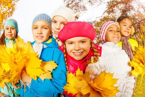 Happy children with beautiful leaves bunches — Stock Photo, Image