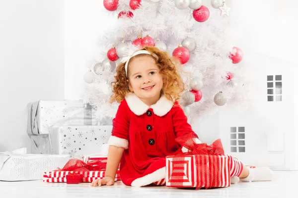 Girl with presents under Christmas tree Stock Picture