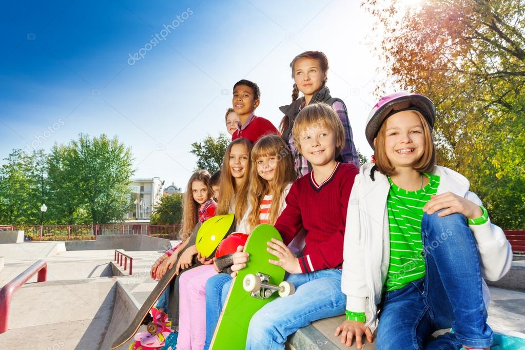 Friends sitting with skateboards