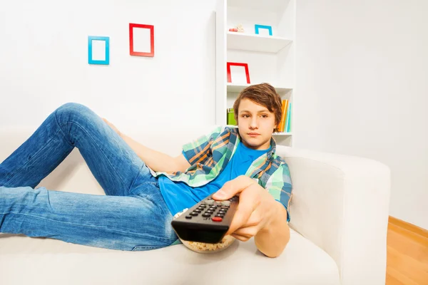 Boy switches remote control — Stock Photo, Image