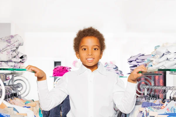 African boy in clothes store
