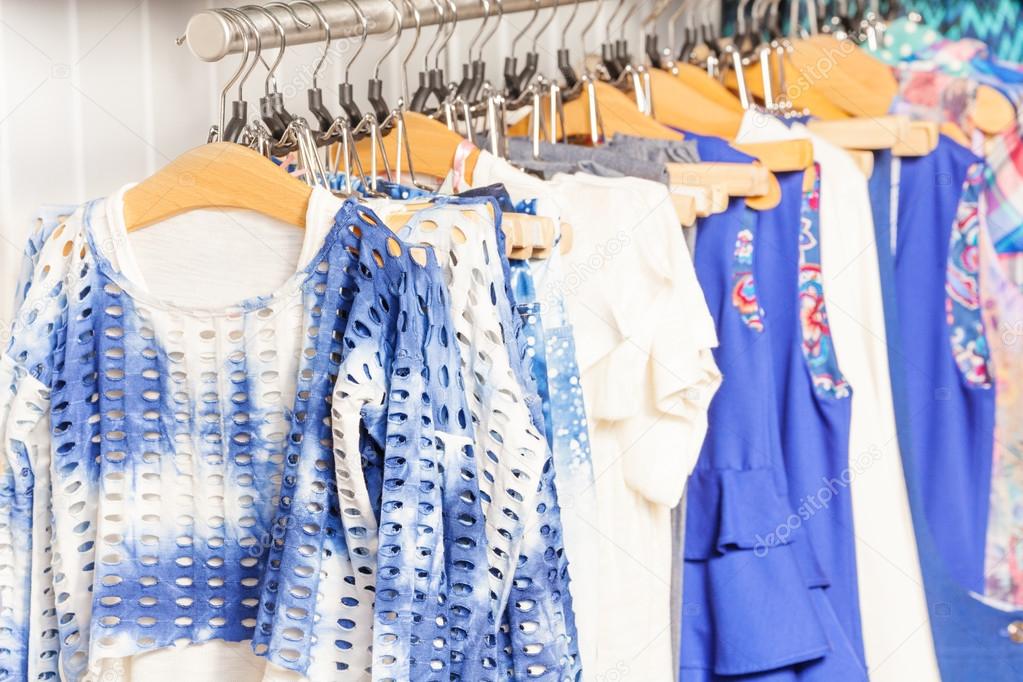 Fashionable blue and white clothes in shop