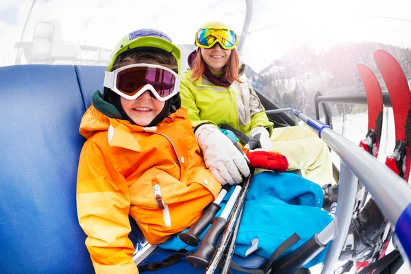 Pojke med mamma på mountain ski lift — Stockfoto