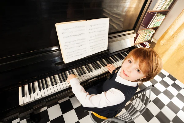 Girl in uniform playing piano — Stock Photo, Image