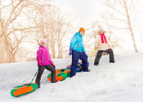 Children walking and carry tubes — Stok fotoğraf