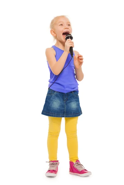 Girl singing karaoke in microphone Stock Image