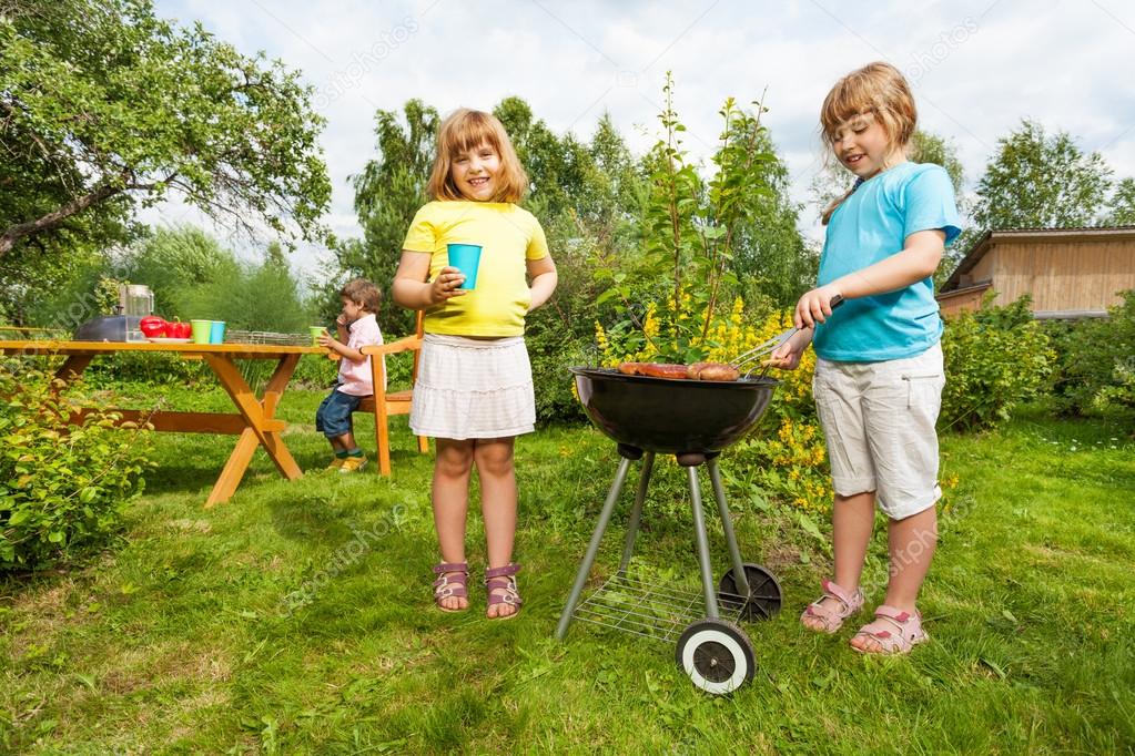 Two girls near grill