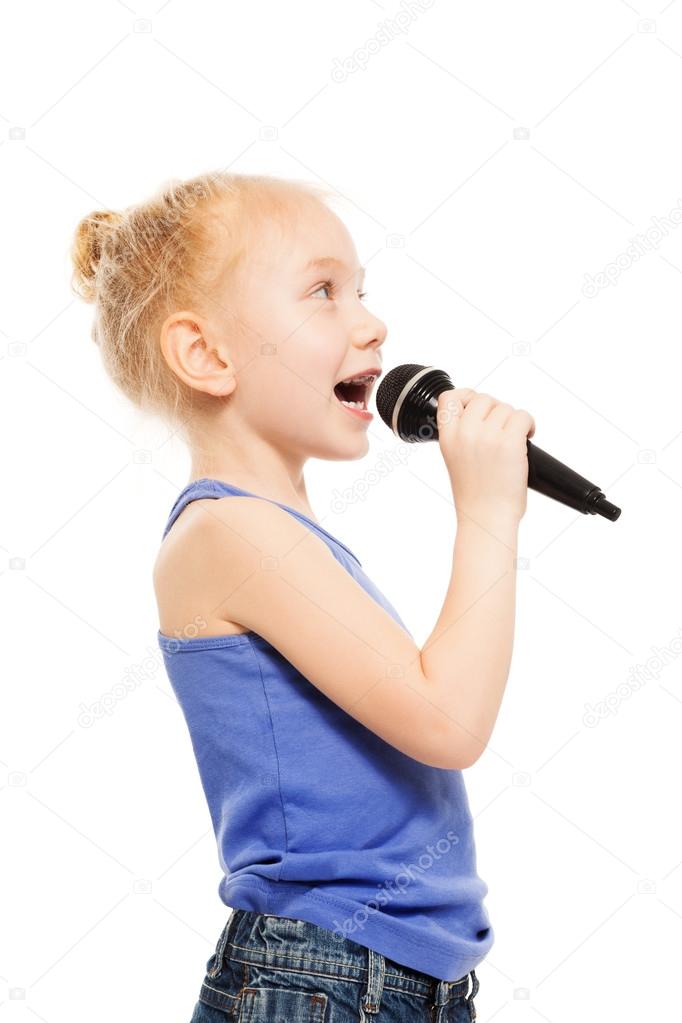 small girl singing in microphone
