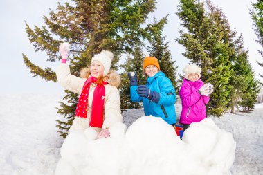Group of children play snowballs game