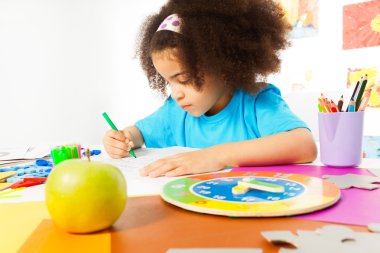 Small girl writing letters