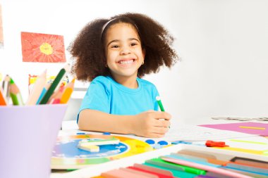 Happy African girl writing letters