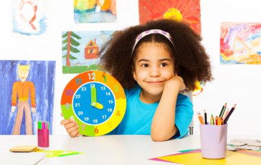 Small African girl showing time