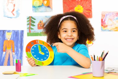 African girl holding carton clock