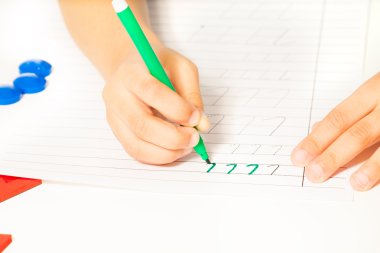 kids hands writing letters
