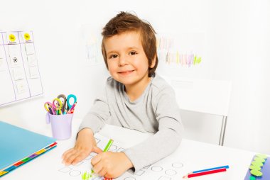 small boy draws with pencil clipart