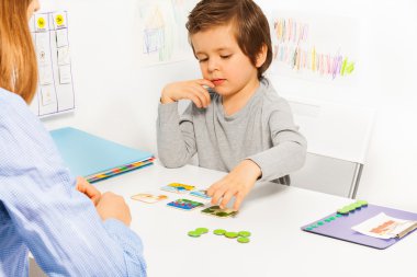 Preschooler boy plays in developing game clipart
