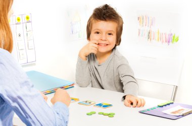 Smiling boy plays developing game