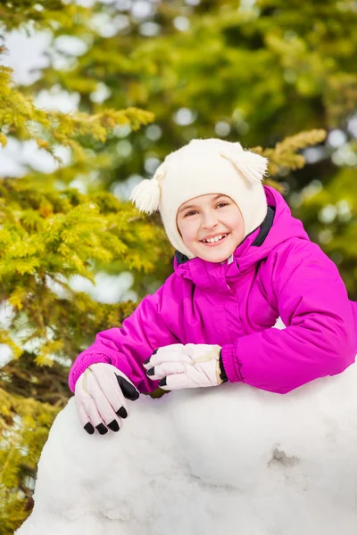 Glad tjej bakom snö vägg — Stockfoto