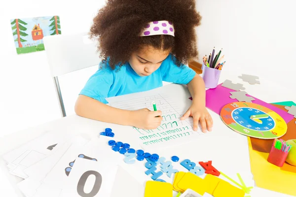 Concentrated African girl writes letters — Stock Photo, Image