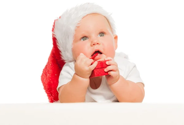 Niedliches Baby mit rotem Weihnachtsmütze — Stockfoto
