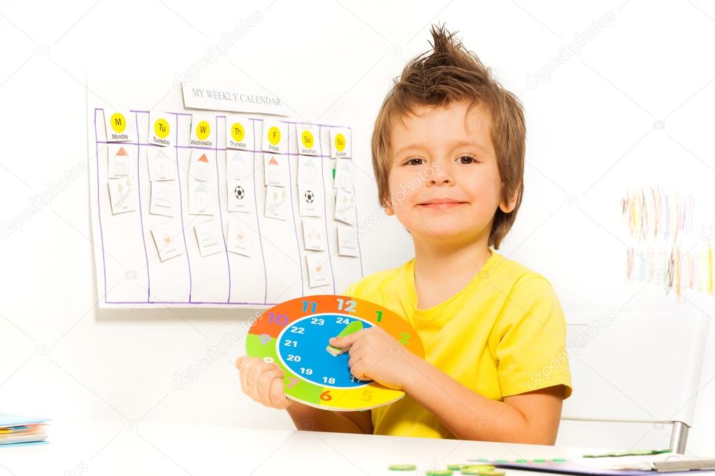 boy holding colorful carton clock