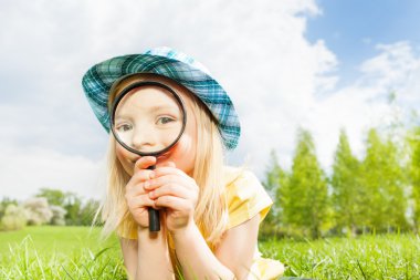 Small beautiful girl with magnifier clipart