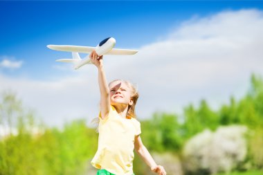 happy girl holding airplane toy