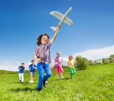 running kids and boy holding airplane
