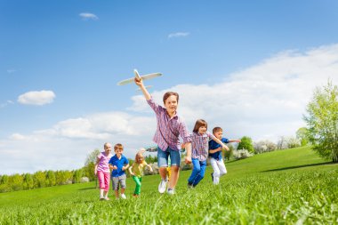 boy with plane toy and kids