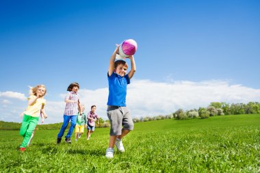 Boy holding rocket toy and children