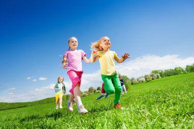 Happy girls and other kids running