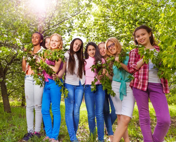 Beautiful teenage girls hold branches — Stock Photo, Image