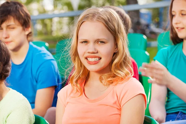 Teenager girl sitting on tribune — Stock Photo, Image