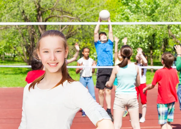 Happy teenager girl with team playing — Stock Photo, Image