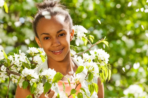 African teenager girl with pear flowers — Stockfoto