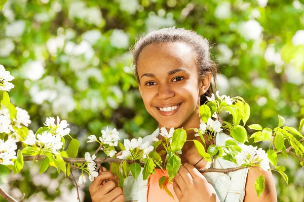 African teenager girl with pear flowers — Stock fotografie