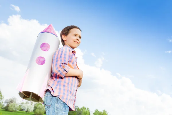 Boy wears paper rocket toy — Zdjęcie stockowe