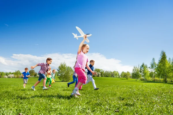 Menina pequena detém brinquedo avião — Fotografia de Stock