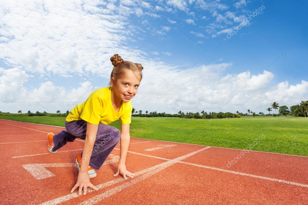 Girl in colorful uniform on start